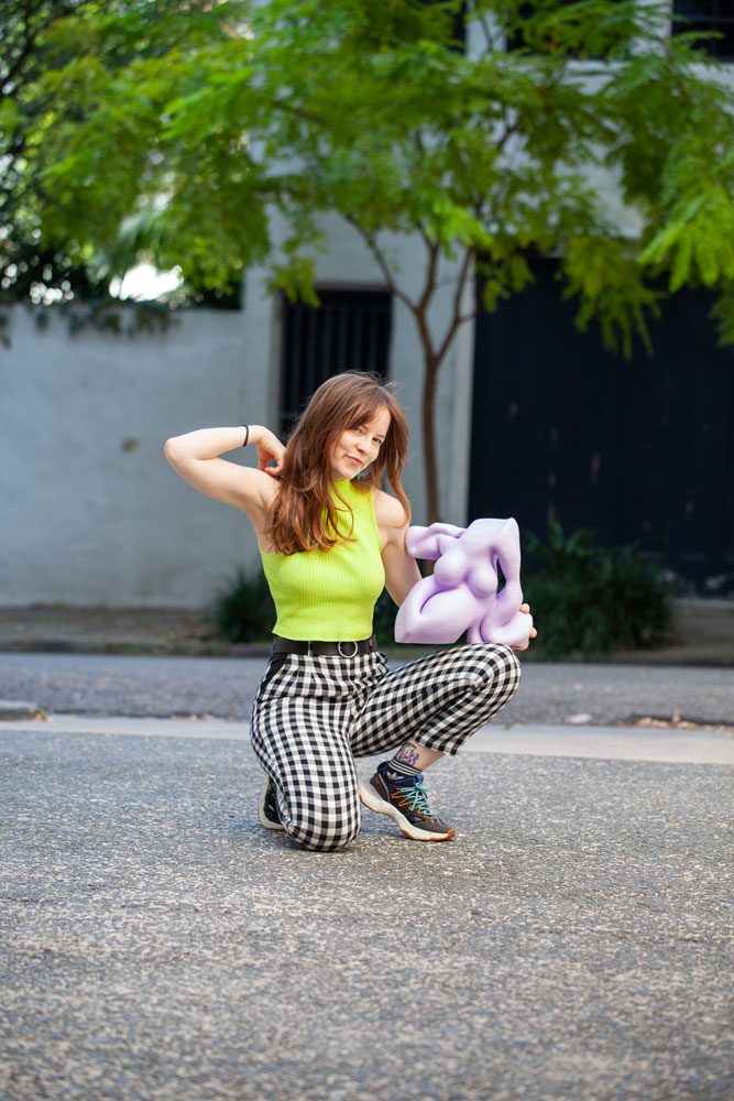 Woman posing with 3D printed sculpture